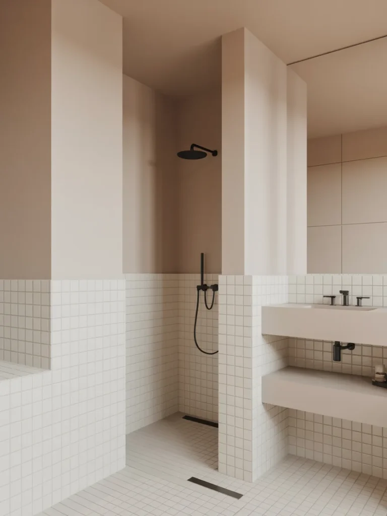 Minimalist bathroom with soft beige tones, grid tile walls, and matte black shower fixtures.