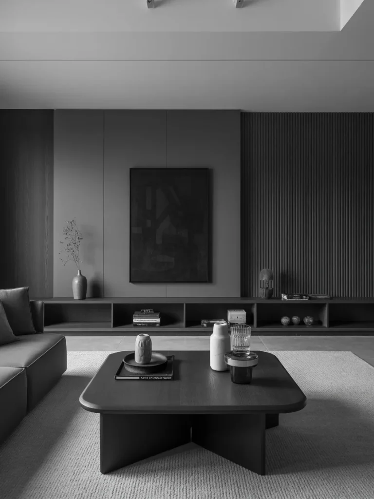 Modern minimalist black and grey living room with clean lines, low furniture, and a sleek monochrome aesthetic.
