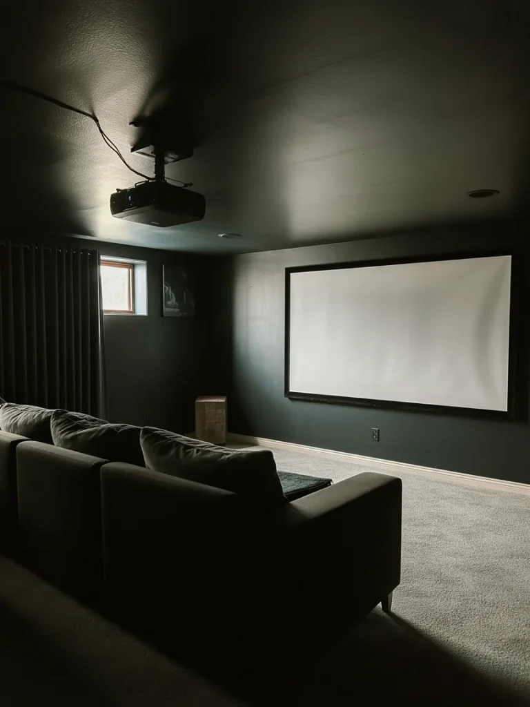 Basement projector setup with wall-mounted screen and ceiling-mounted projector