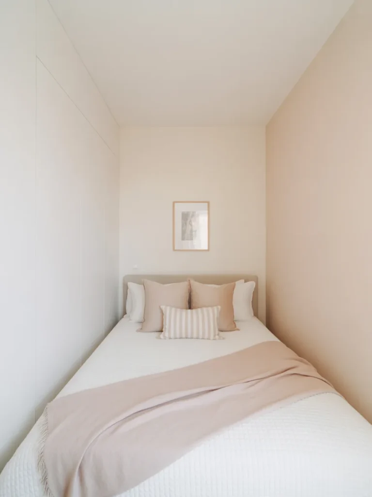 Tiny bedroom with light neutral color palette and minimalist bed styling